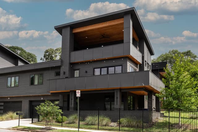 Corner view of the residence showing stacked terraces and covered rooftop pavilion