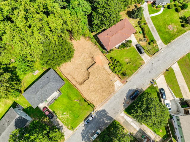 Wide aerial view of the vacant lot within the residential neighborhood
