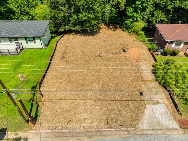 Elevated view of the vacant lot and adjacent homes from the street