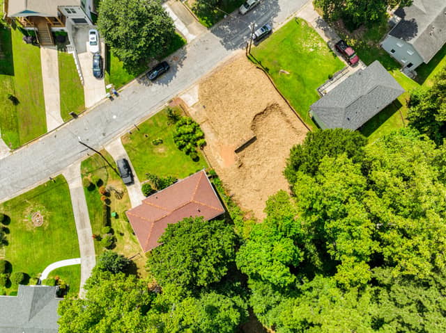 Angled aerial view of the vacant lot beside the neighborhood street