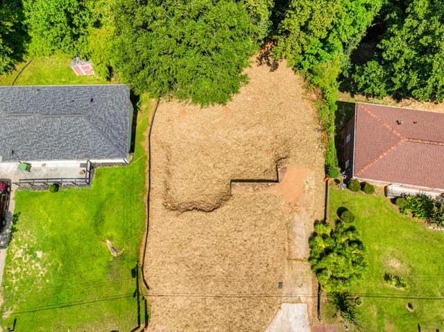 Overhead view of the vacant lot with neighboring homes on either side