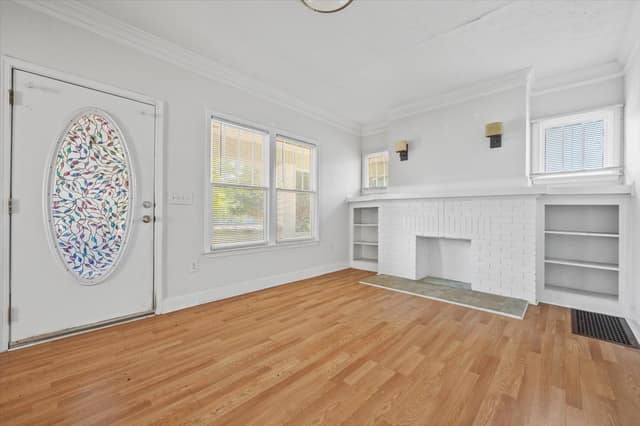 Entry with stained-glass door opening into the fireplace living room