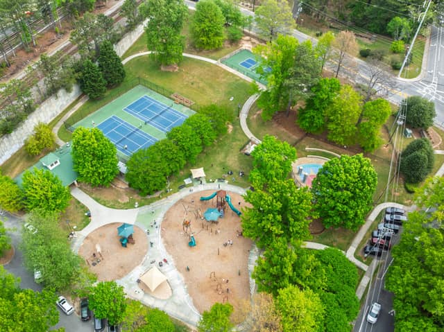 Aerial view of Ashford Park with tennis courts, playground, and green space near 1607 Wayland Circle