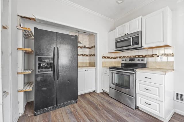 Kitchen with full-size refrigerator, stainless range, and generous cabinetry