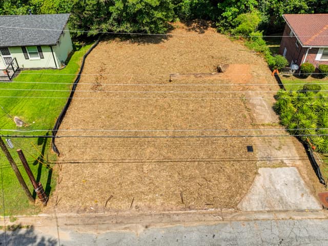 Wide elevated view of the vacant lot and neighboring yards