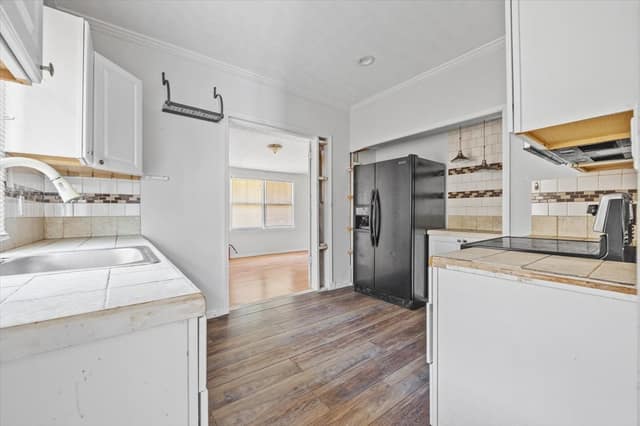 Kitchen looking toward the sink and adjoining room