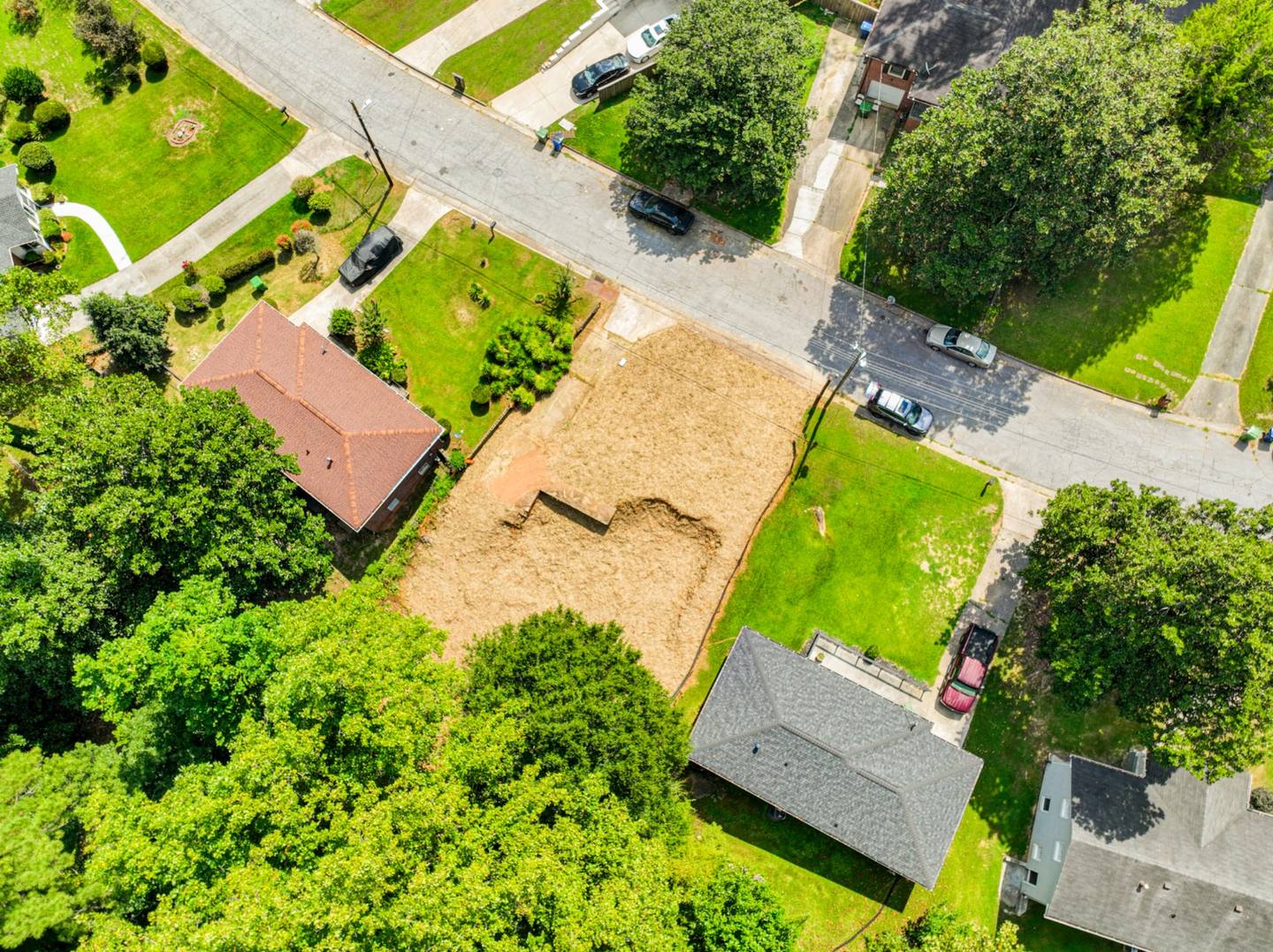 Aerial view of the vacant lot at 232 Oakcliff Ct NW among neighboring homes and trees