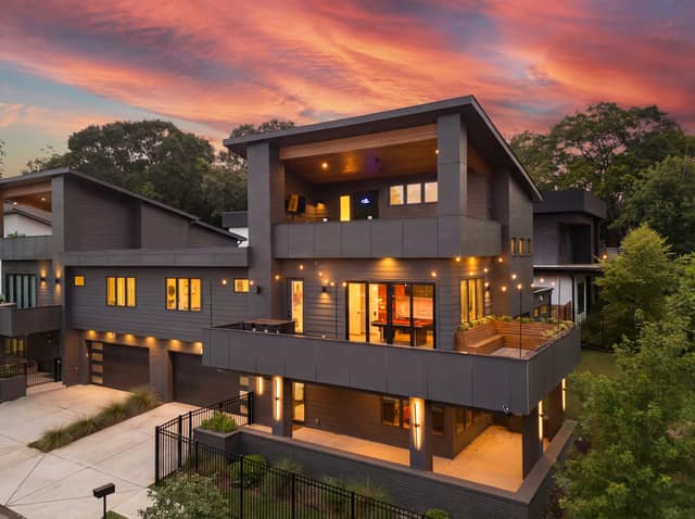 Front elevation of 10 Moreland Avenue at twilight with terraces illuminated