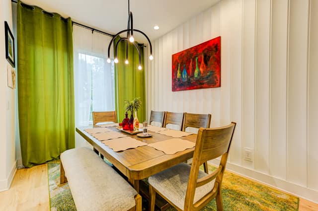 Dining room with pendant lighting and paneled wall detail